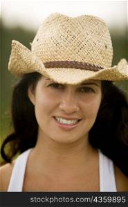Portrait of a young woman wearing a cowboy hat