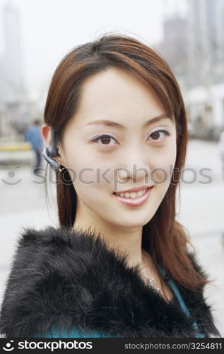 Portrait of a young woman wearing a hands free device