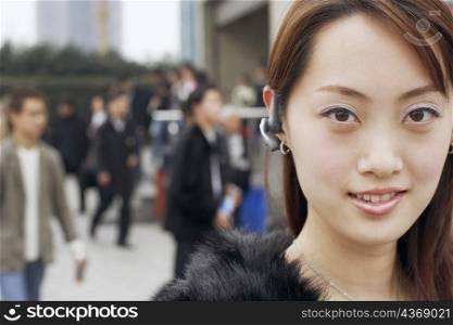 Portrait of a young woman wearing a hands free device