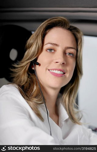 Portrait of a young woman wearing a hands free device and listening to music