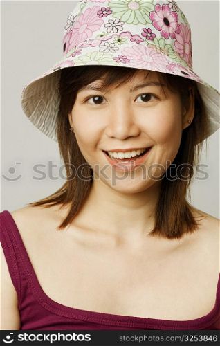 Portrait of a young woman wearing a hat and smiling