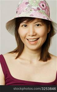 Portrait of a young woman wearing a hat and smiling
