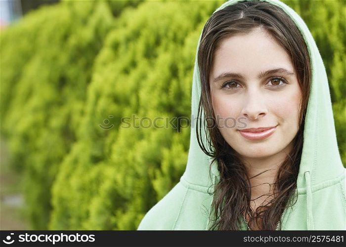 Portrait of a young woman wearing a hooded shirt