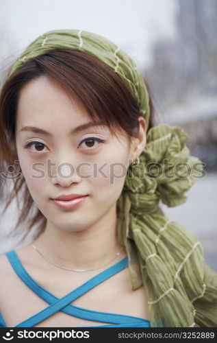 Portrait of a young woman wearing a scarf