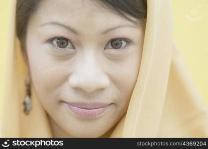 Portrait of a young woman wearing a scarf