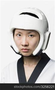Portrait of a young woman wearing a sports helmet