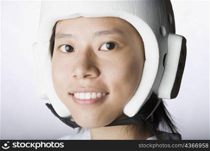 Portrait of a young woman wearing a sports helmet