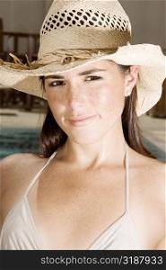 Portrait of a young woman wearing a straw hat