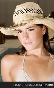 Portrait of a young woman wearing a straw hat