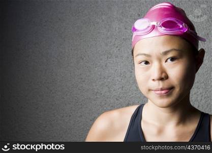 Portrait of a young woman wearing a swimming cap
