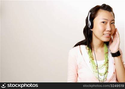 Portrait of a young woman wearing headphones and smiling