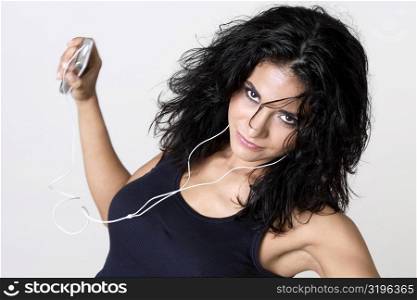 Portrait of a young woman wearing headphones listening to music