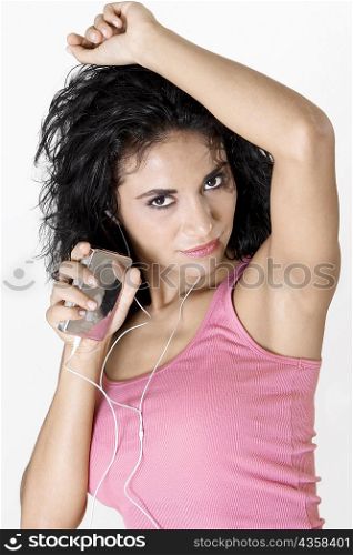 Portrait of a young woman wearing headphones listening to music