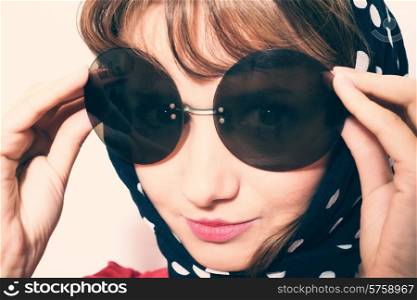 Portrait of a young woman wearing sunglasses and headscarf