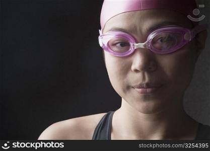 Portrait of a young woman wearing swimming goggles
