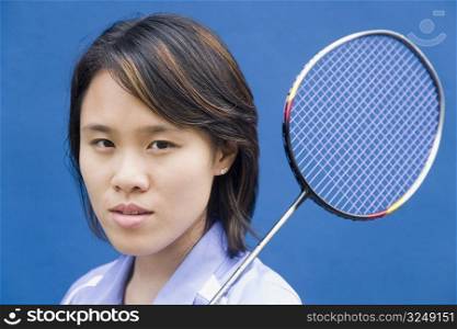 Portrait of a young woman with a badminton racket