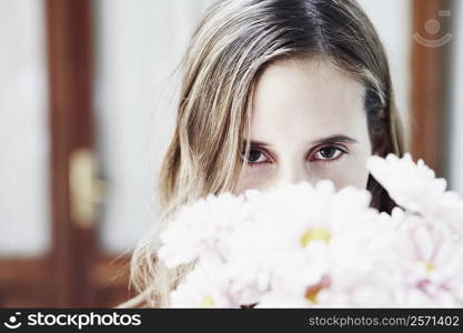 Portrait of a young woman with a bunch flowers