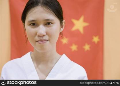 Portrait of a young woman with a Chinese flag in the background