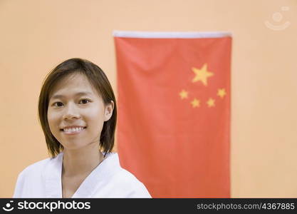 Portrait of a young woman with a Chinese flag in the background