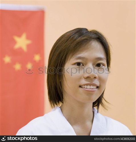 Portrait of a young woman with a Chinese flag in the background