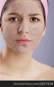 Portrait of a young woman with a facial mask