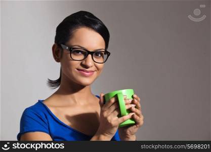 Portrait of a young woman with a mug of tea