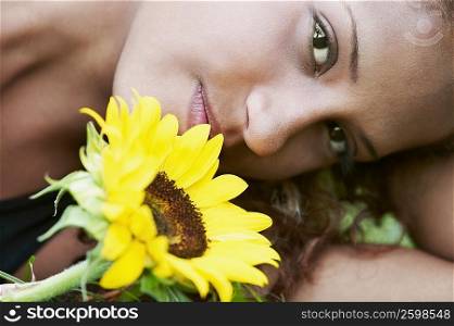 Portrait of a young woman with a sunflower