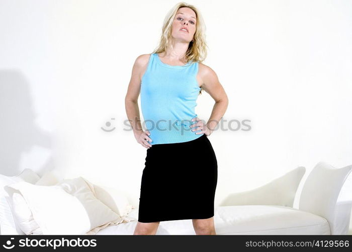 Portrait of a young woman with arms akimbo