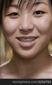 Portrait of a young woman with braces on her teeth