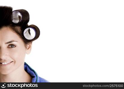 Portrait of a young woman with curlers in her hair