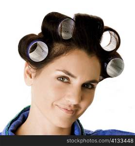 Portrait of a young woman with curlers in her hair
