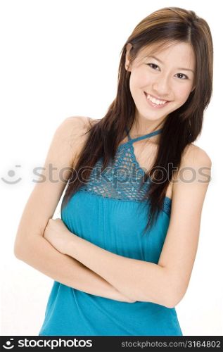 Portrait of a young woman with her arms crossed and smiling