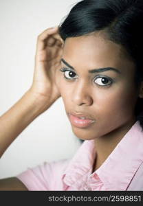 Portrait of a young woman with her hand in her hair