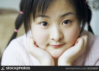 Portrait of a young woman with her hand on her chin