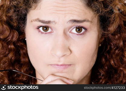 Portrait of a young woman with her hand on her chin