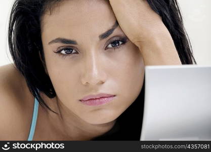 Portrait of a young woman with her hand on her head