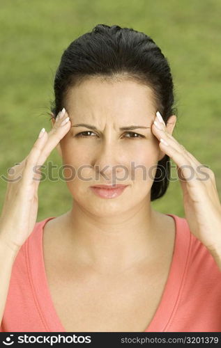 Portrait of a young woman with her hands on her head