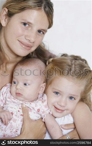 Portrait of a young woman with her two baby girls