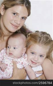 Portrait of a young woman with her two baby girls