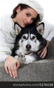 Portrait of a young woman with husky