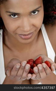 Portrait of a young woman with strawberries in her hands