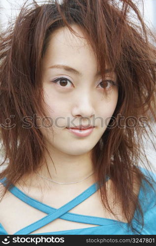 Portrait of a young woman with tousled hair