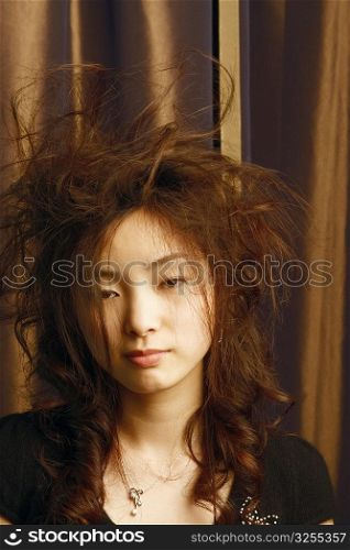 Portrait of a young woman with tousled hair