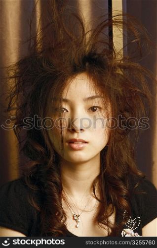 Portrait of a young woman with tousled hair