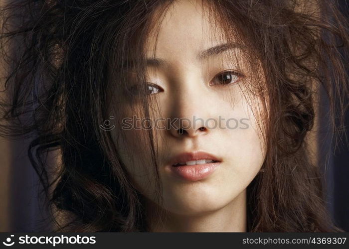 Portrait of a young woman with tousled hair