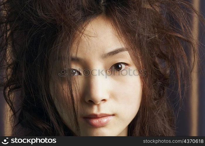 Portrait of a young woman with tousled hair