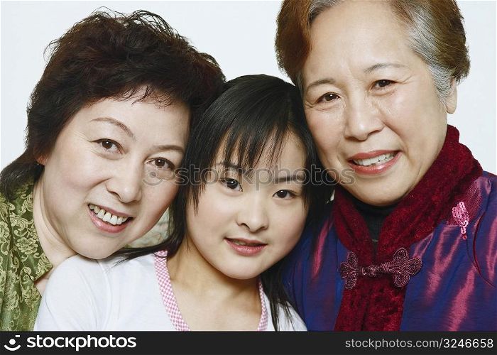 Portrait of a young woman with two mature women smiling