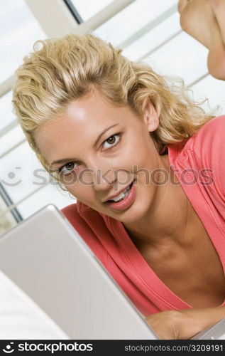 Portrait of a young woman working on a laptop