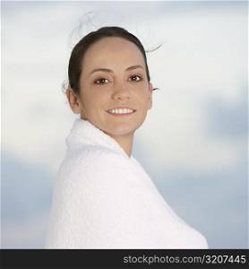 Portrait of a young woman wrapped in a towel