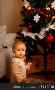 Portrait of adorable baby near Christmas tree&#xA;